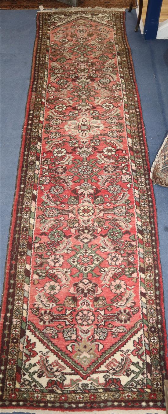 A Persian red ground runner 304 x 77cm